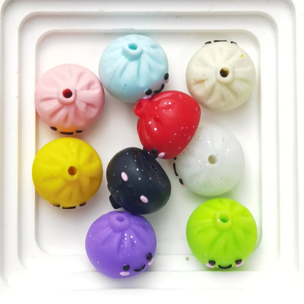 Example assortment of smiling bao bun silicone focal beads in mixed colors