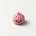 Pink bao bun silicone focal bead with a smiling face