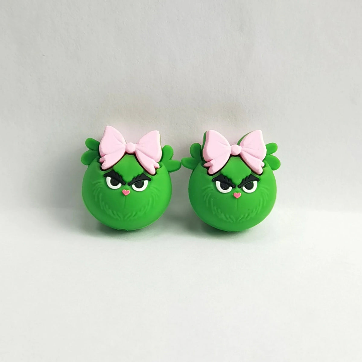 Green Character - Pink Bow silicone focal bead design on a pale background