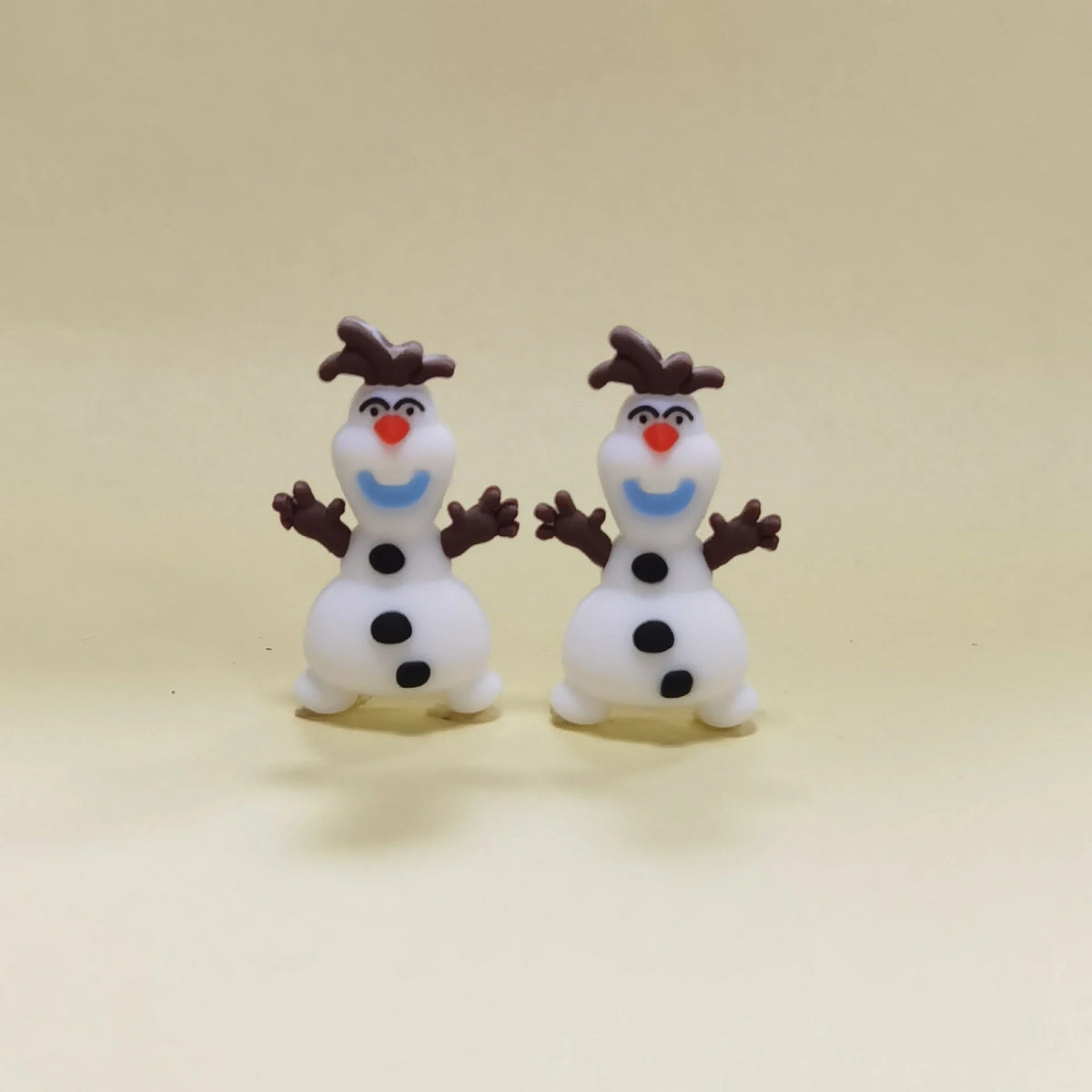Snowman - Twig Arms silicone focal bead design on a pale background