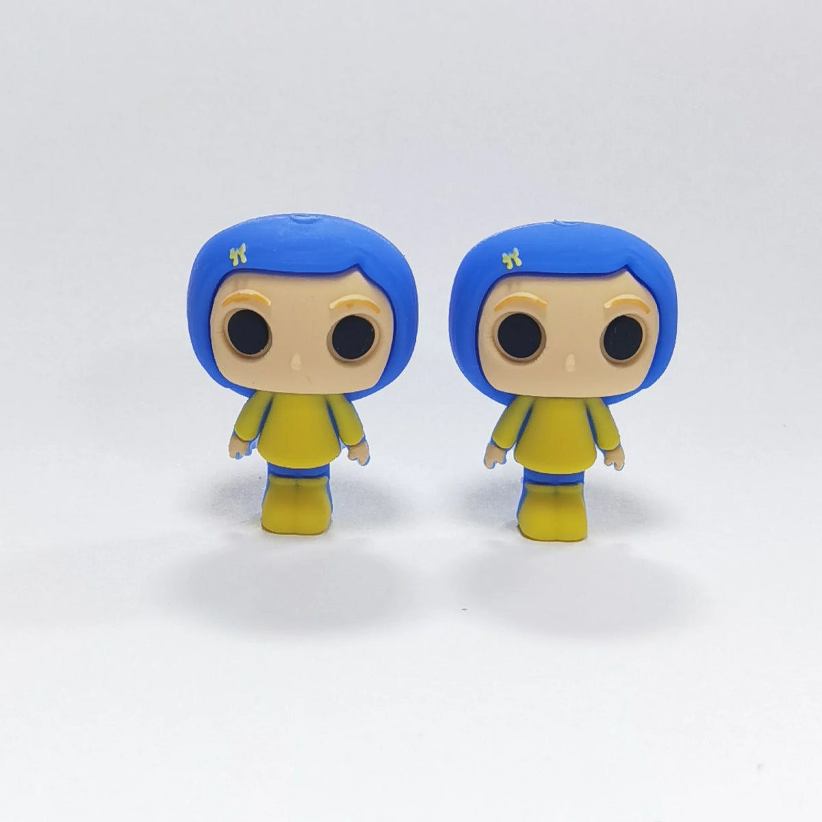 Blue-Haired Figure - Yellow Coat Halloween silicone focal bead design on a pale background