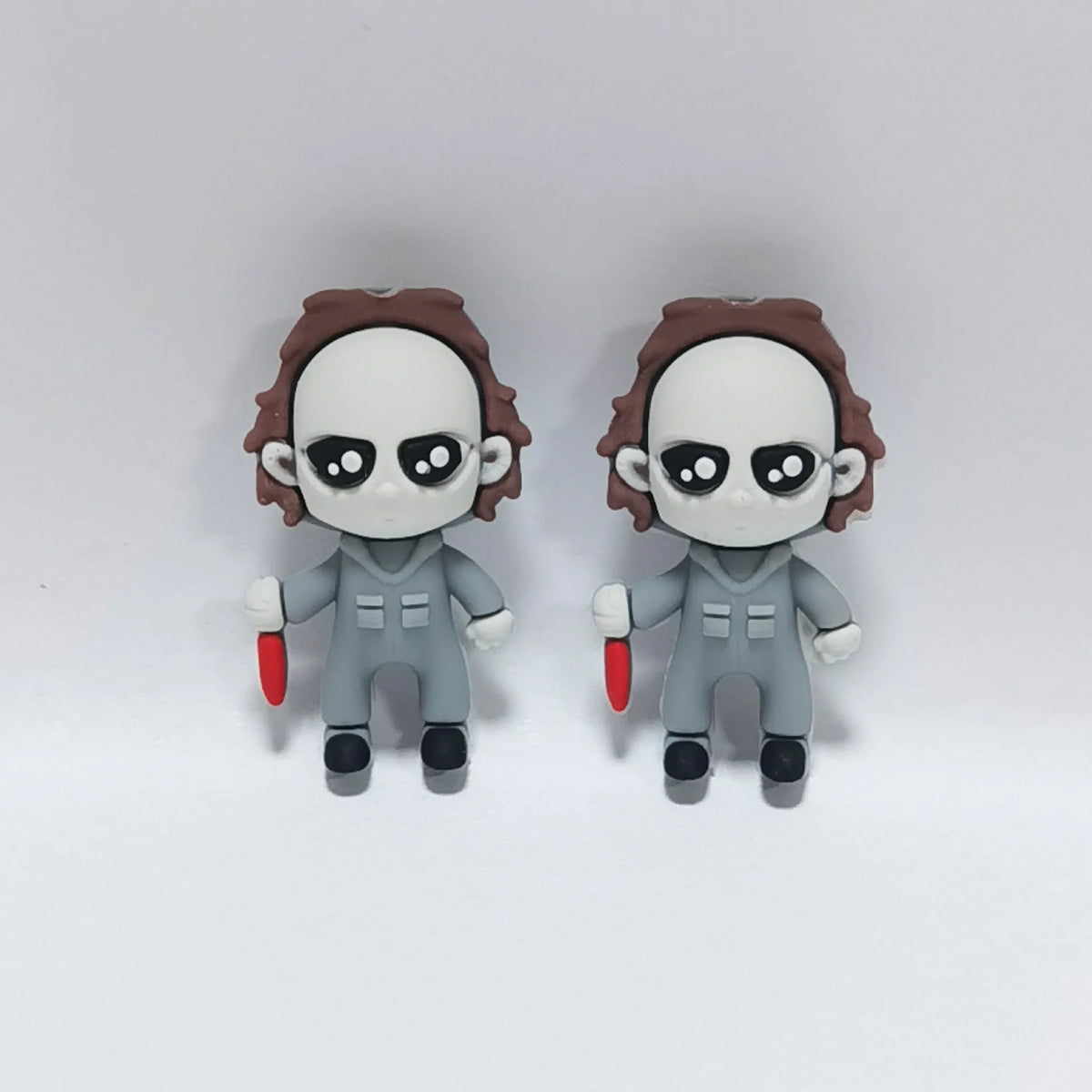 Masked Figure - Gray Outfit Halloween silicone focal bead design on a pale background