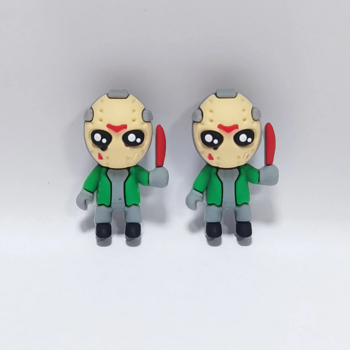 Masked Figure - Green Jacket Halloween silicone focal bead design on a pale background