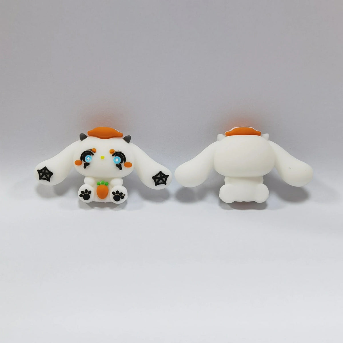 White Long-Eared Character - Pumpkin Hat Halloween silicone focal bead design on a pale background