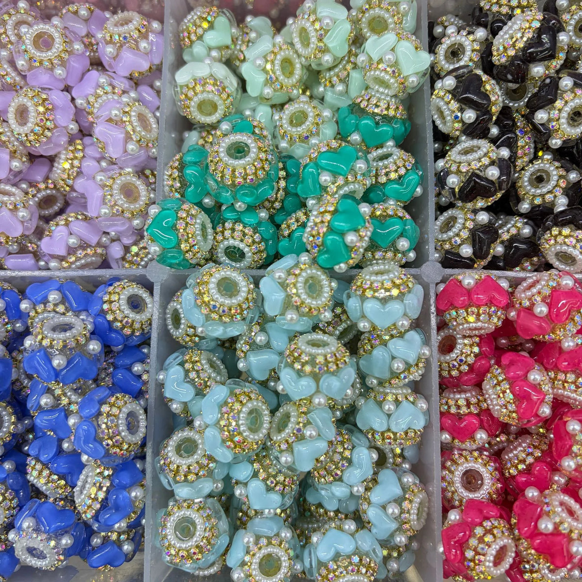 Supplier examples of gold-tone rhinestone heart barrel beads in several colors for custom color reference