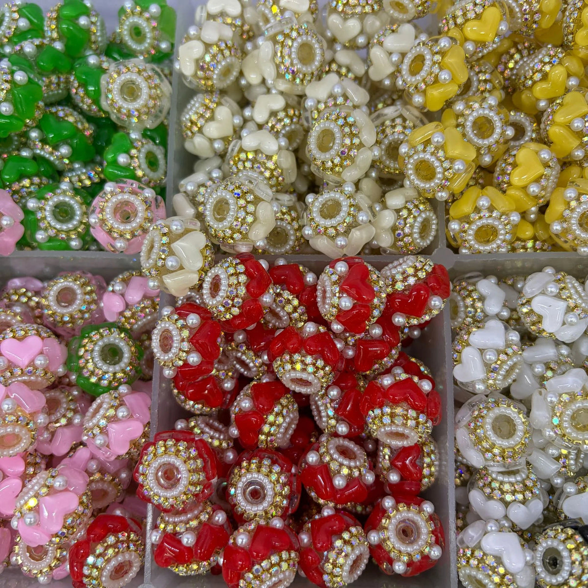 Example gold-tone rhinestone heart barrel beads in assorted colors in a sorting tray