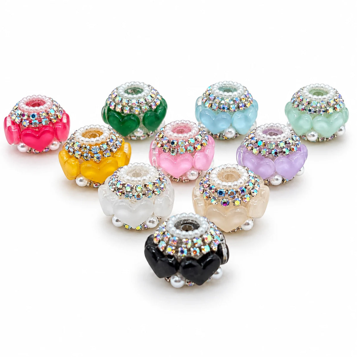 Example assortment of colored acrylic heart barrel beads with silver-tone rhinestone trim on a white background