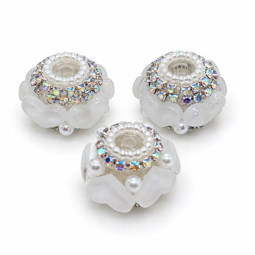 Three white acrylic heart barrel beads with silver-tone rhinestone trim and pearl-like accents on a white background