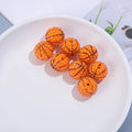 Orange basketball-style resin beads with black lines and a textured surface