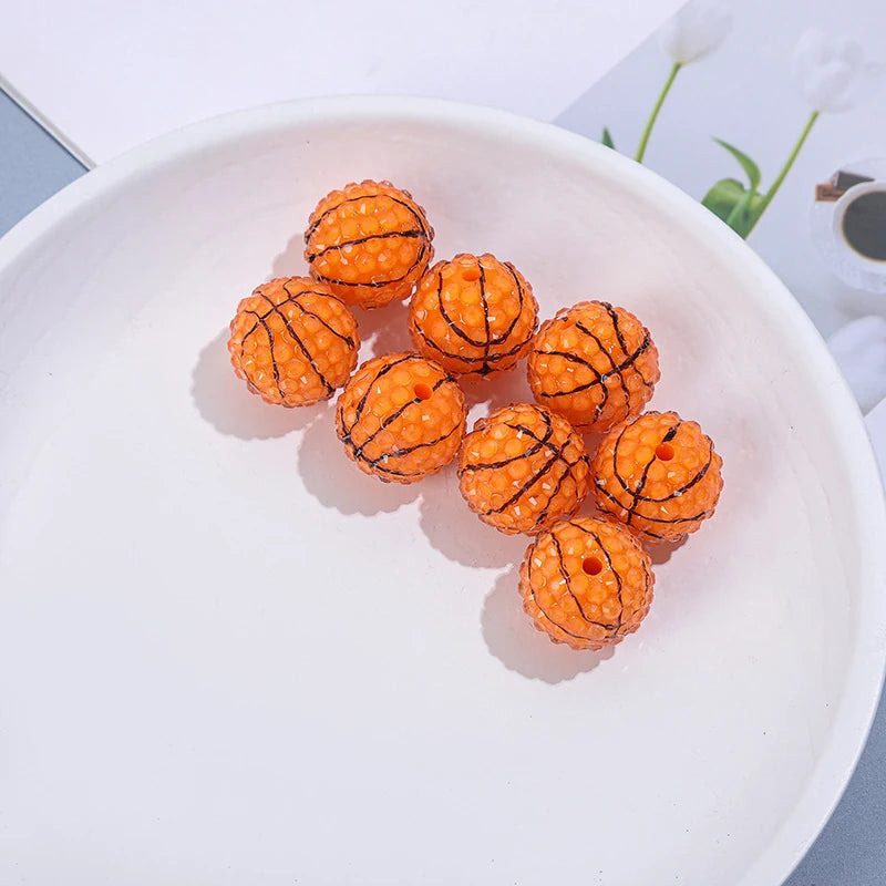 Orange basketball-style resin beads with black lines and a textured surface